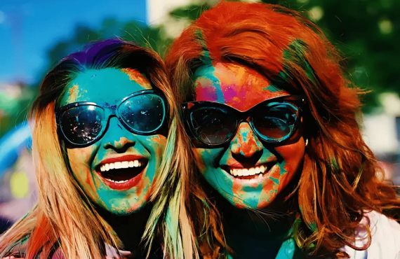 2 gals with holi colors on her face